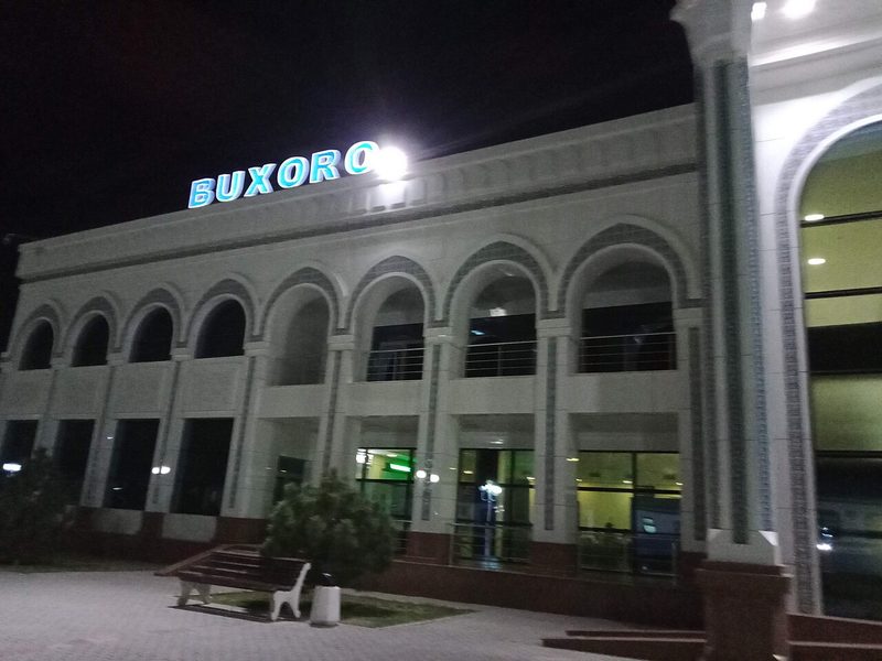 Bukhara railway station building exterior at night